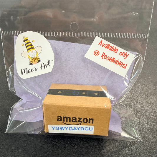 Moe's miniature Amazon mystery box — tiny sealed box with genuine Amazon tape