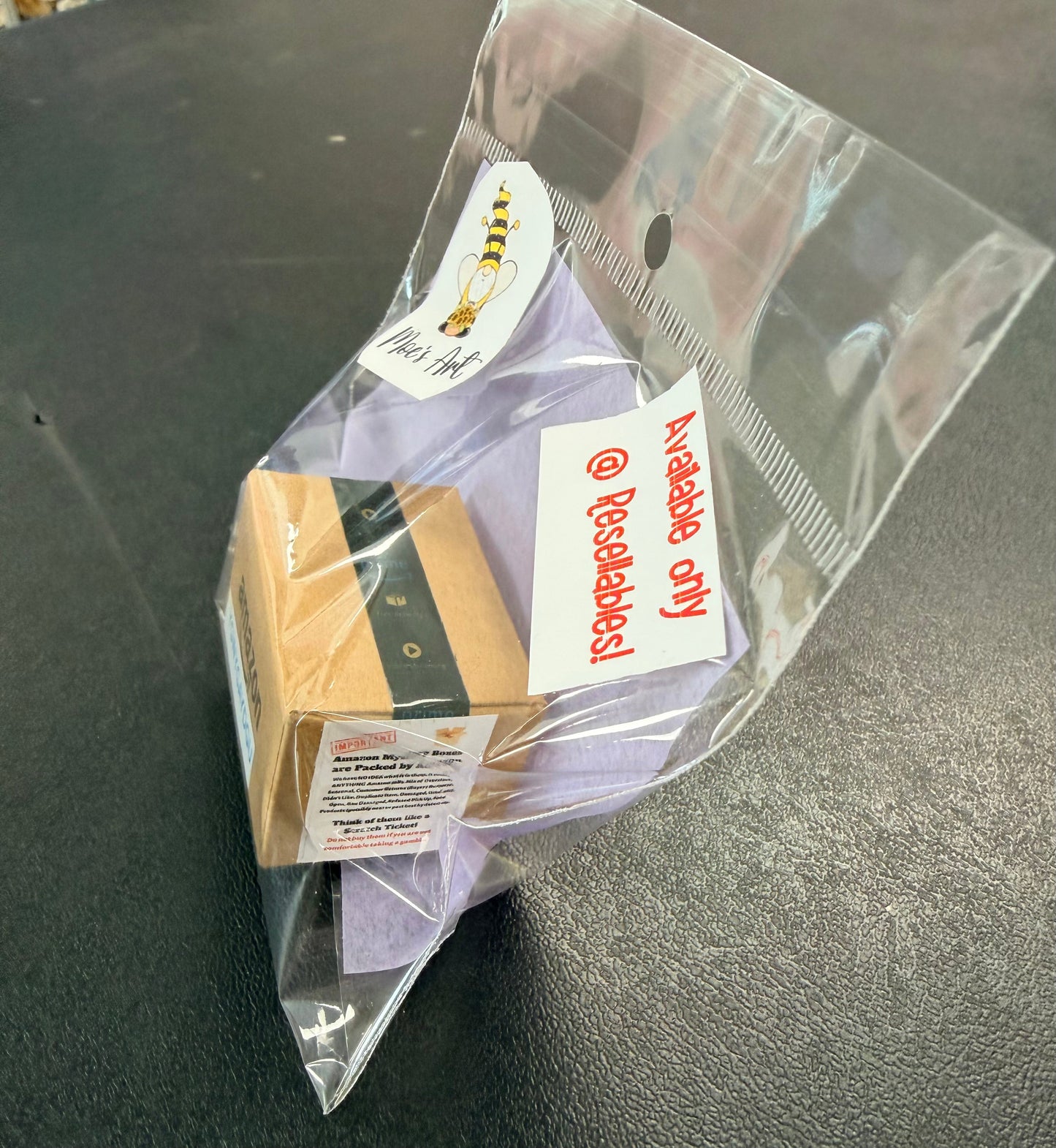 Miniature Amazon mystery box in hand for scale